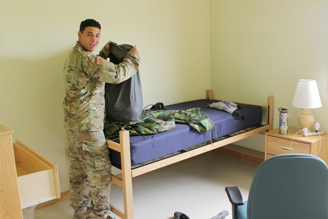 Unpacking in his new room