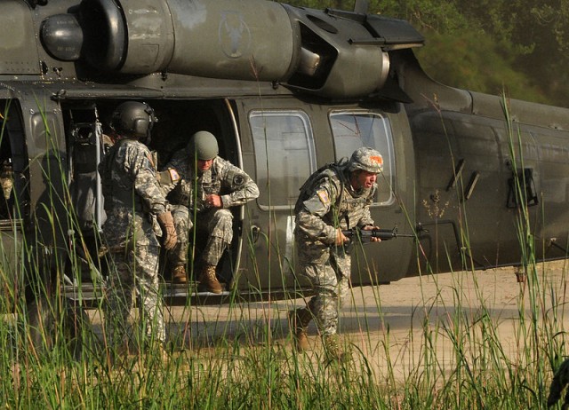 Spc. Derek Michael exits a UH-60 Blackhawk