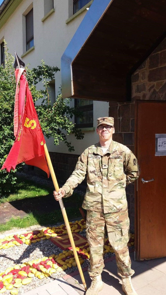 Spc. George Kallas holding the Bravo Battery, 5-7th ADA's guideon
