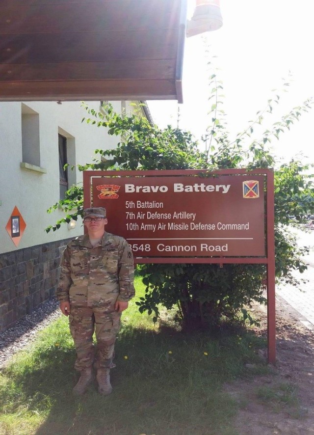 Spc. George Kallas in front of Bravo Battery, 5-7th ADA