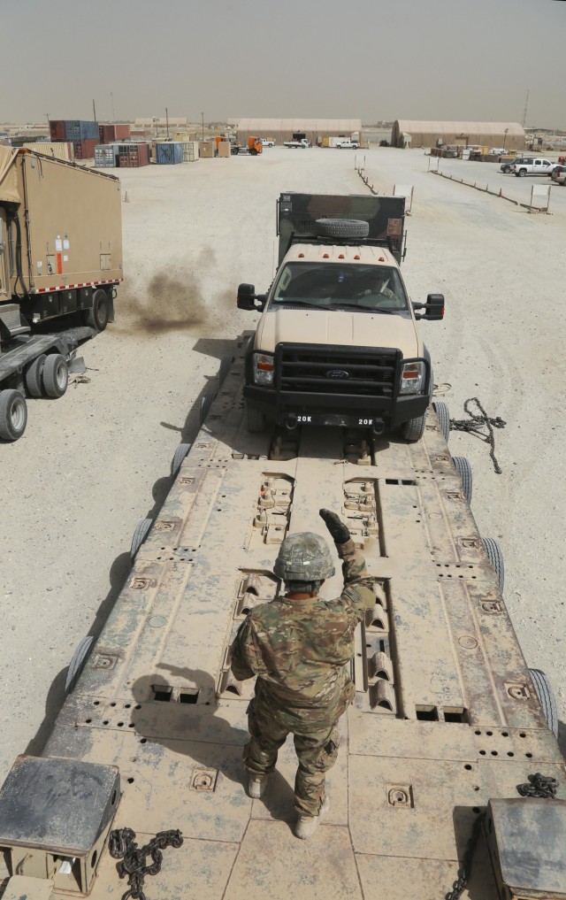 PFC guides truck onto trailer