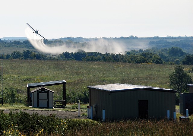 A contract pilot sprays for noxious weeds at Fort Riley, Kansas