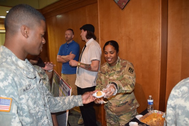 Sgt. Brenda Collins serves arepa de maiz