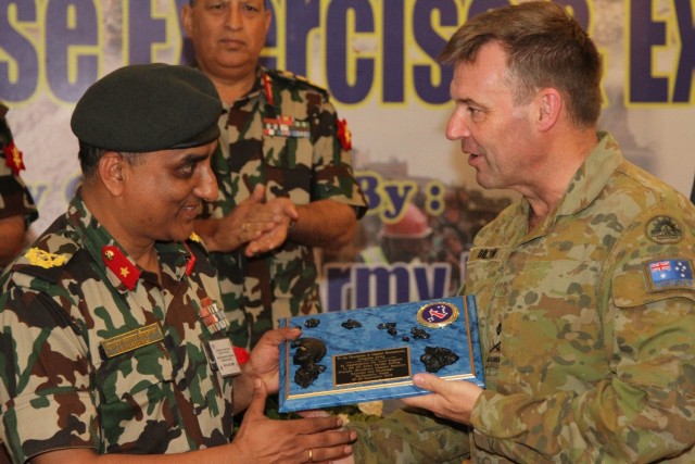 Maj. Gen. Gregory C. Bilton, deputy commanding general, U.S. Army Pacific (right), presents a plaque of appreciation and support to the Nepalese Army Director