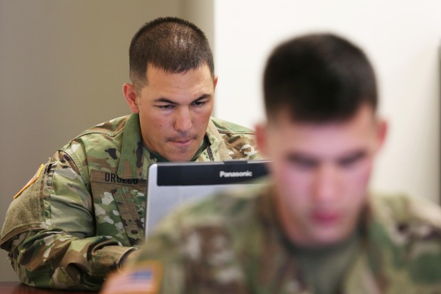 Spc. Orozco types a 400-word essay on improving Soldier readiness