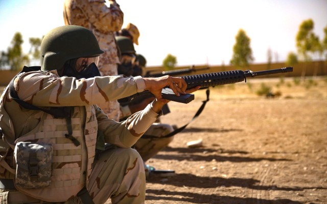 A peshmerga soldier loads his M16 rifle