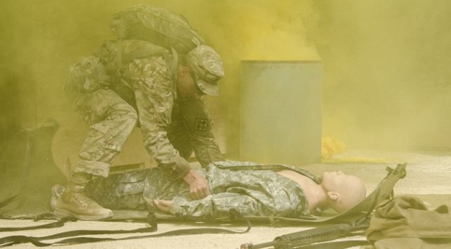 Surrounded by smoke, Sgt. David Hull moves a mannequin