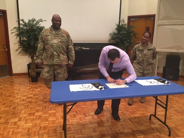 Louis D'Angelo, Zama American High School Principal, signs charter aggreement