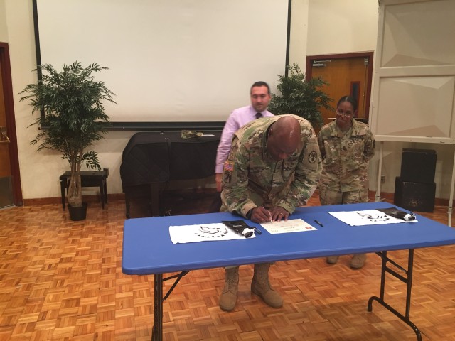 Col. Andre R. Pippen, MEDDAC-J Commander, signs charter agreement