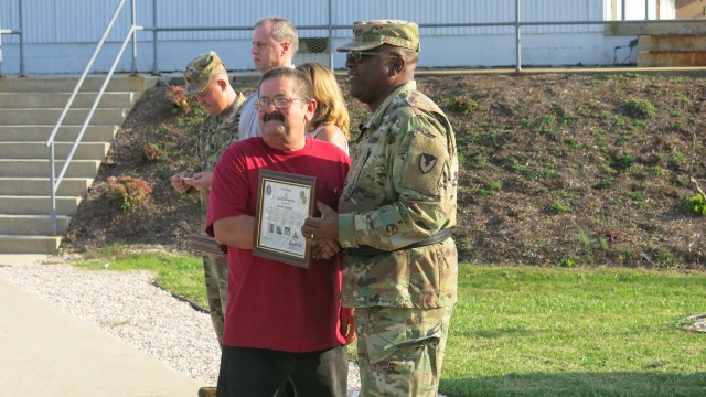 Brig. Gen. Richard Dix, Commanding General of Joint Munitions Command presents Letterkenny Munitions Center employee, Mr. David Grissinger, with a plaque during a ceremony to recognize and thank Vietn
