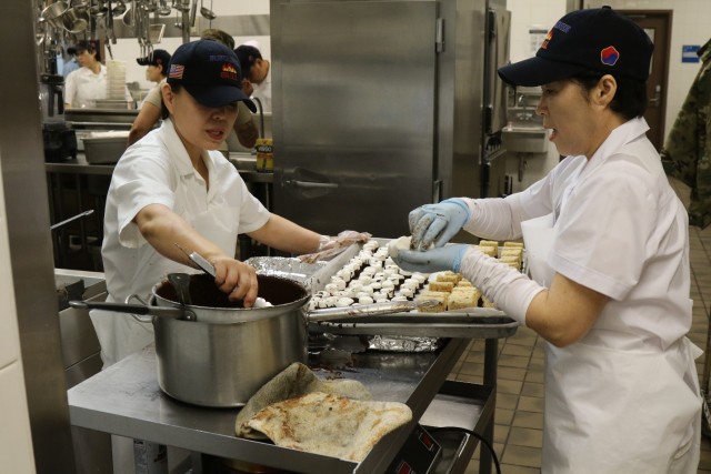 Korean Nationals who work at the Sustainer Grill Dining Facility make appetizers or Hors d'oeuvres in preparation for the Thanksgiving Feast.