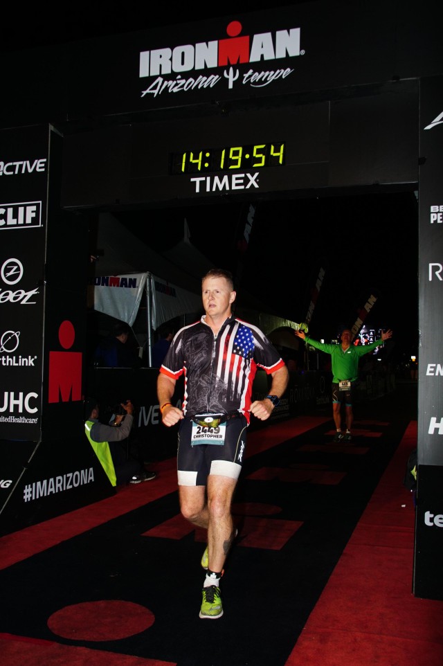 1st Sgt. Mitter crosses the finish line of the Ironman