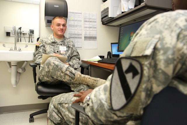 A mental health specialist provides triage to a soldier