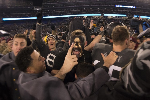 Army West Point Football players celebrate after winning the 117th Army Navy Game