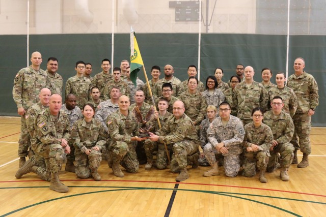 Soldiers of the United States Army Correctional Activity-Korea pose for a group photo with the Brig. Gen. Thomas F. Barr Award for being the best Military Police unit assigned to, attached to, or supp
