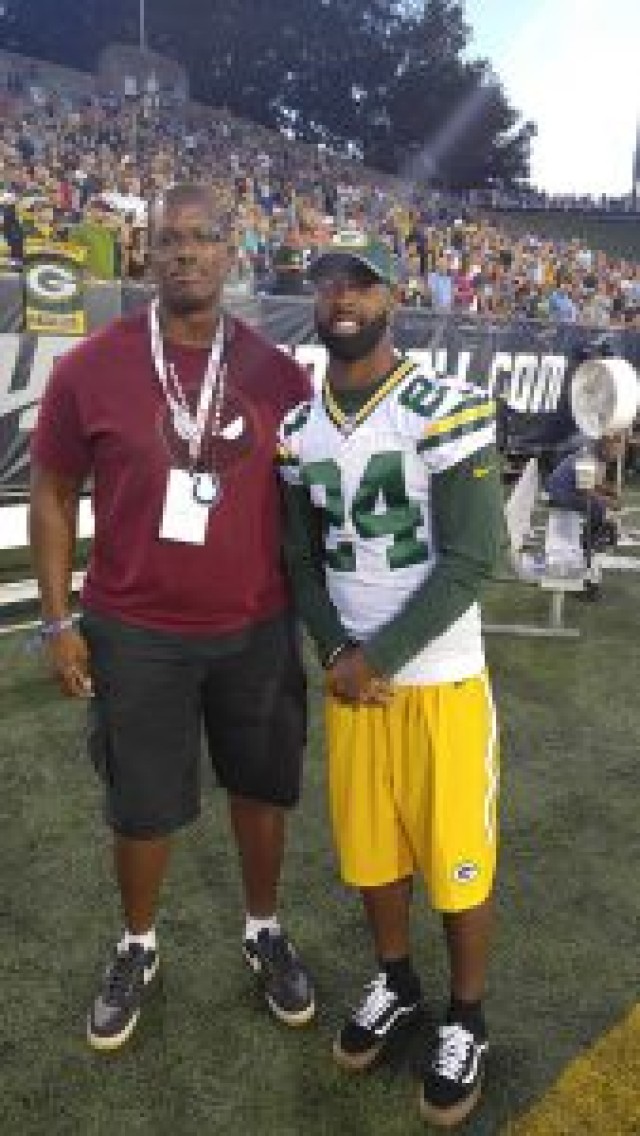 Staff Sgt. Kyle Richardson stands with Green Bay Packers cornerback Jarrett Bush