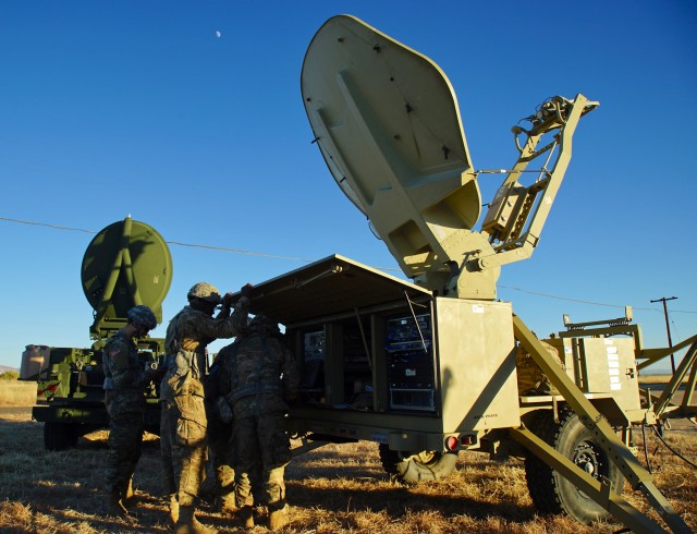 Soldiers work on a communications sytem