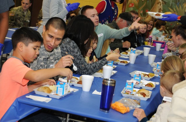 Gathering for the holidays: Students, parents, school staff share holiday meal