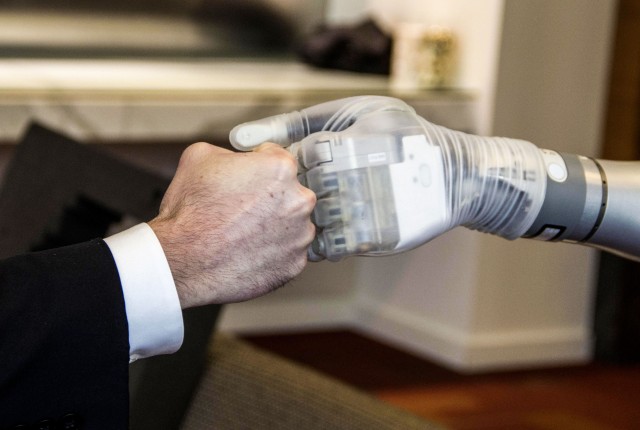 Dr. Justin Sanchez fist-bumps with advanced