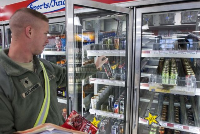 Spc. Kevin Alexander of 138th Quartermaster Company grabs an energy drink