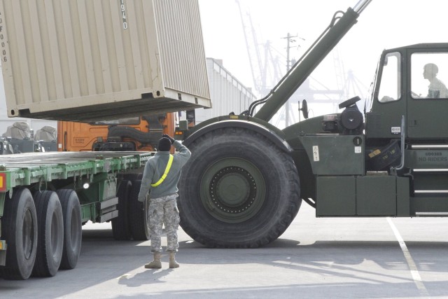 19th ESC Soldiers load a 1-6 Heavy Attack Reconnaissance Squadron Rotation cargo on a truck to be transported to the 2ID at Camp Humphreys.