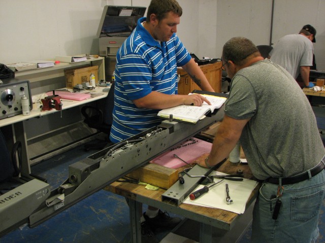 Letterkenny Munitions Center employees, Mr. Travis Reasner and Mr. Timothy Varner, inspect a LAU-128 launcher.