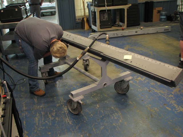 Letterkenny Munitions Center employee, Ms. Jennifer Carbaugh, hooks up a test set to a LAU-128 launcher.