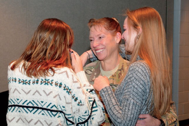 Army Col. Beth Prekker greets her daughters
