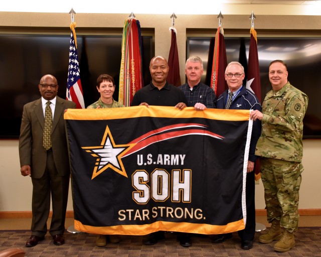 MG Holcomb Presents USAMMDA with Star Strong Flag