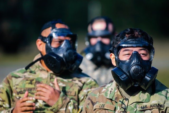 Soldiers from Headquarters and Headquarters Company, 301st Maneuver Enhancement Brigade, prepare to enter a mask confidence chamber