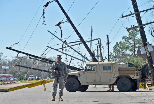 Staff Sgt. Casey Delcambre directs traffic in New Orleans East, Feb. 10, 2017