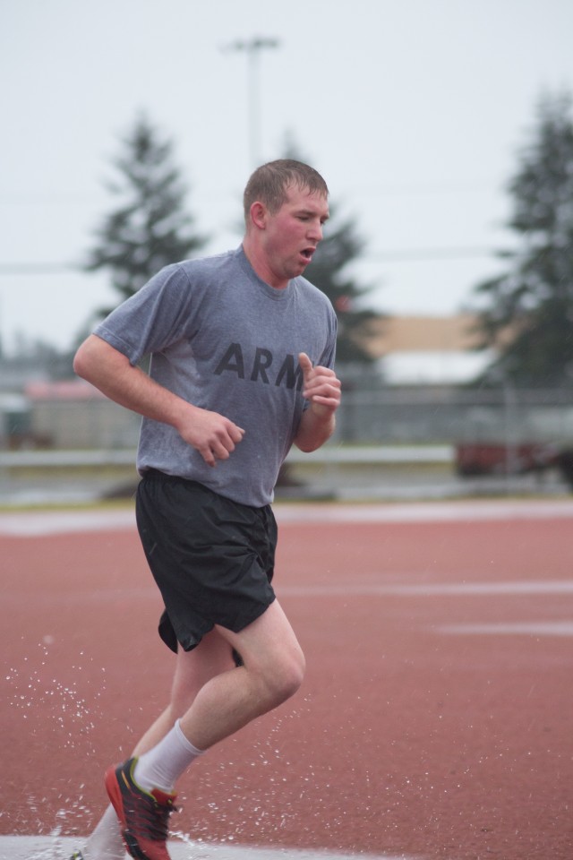 Spc. Christopher R. Williams races towards the finish line of the 2-mile run portion of the Army Physical Fitness Test