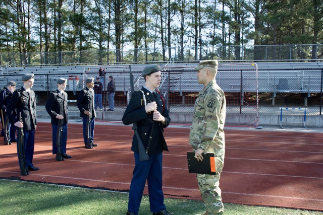 U.S. Army Officer Guides JROTC Cadet at Competition