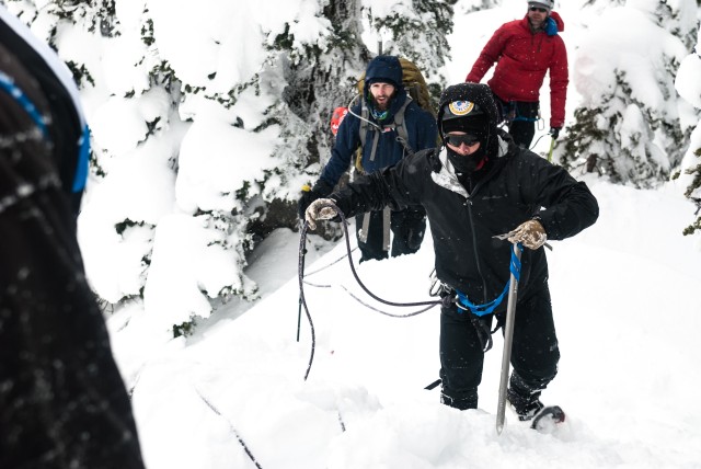 A student practices glacier travel as part of a mountaineering rope team, at the JBLM Alpine Club basic alpine course, Mount Rainier National Park, Washington