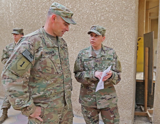 Master Sgt. Stephanie Rhoads discusses a VIP visit with Command Sgt. Maj. Joseph Cornelison