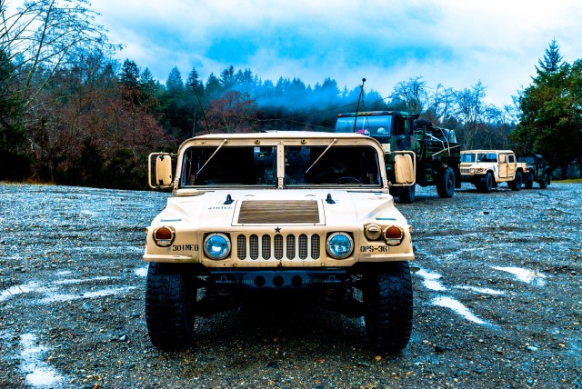 Soldiers from the 301st Maneuver Enhancement Brigade prepare to depart for a convoy