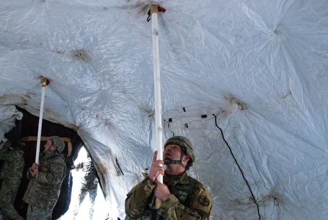 Soldiers from the 301st Maneuver Enhancement Brigade assemble a deployable rapid assembly shelter