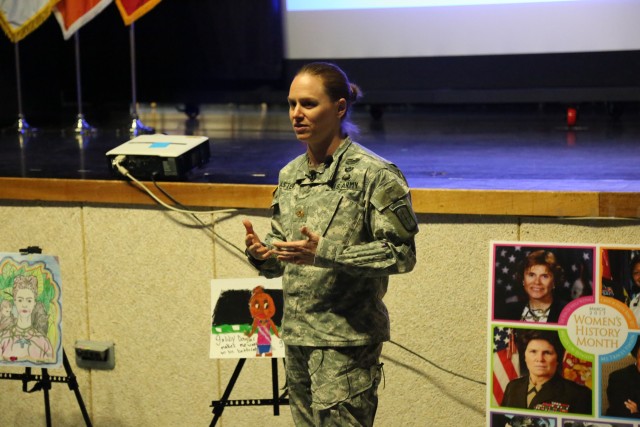 U.S. Army Reserve Maj. Lisa Jaster speaks to the importance of 'deleting the adjective' at the Women's History Month observance at the Camp Henry theater, March 28, 2017. Jaster is the first female re