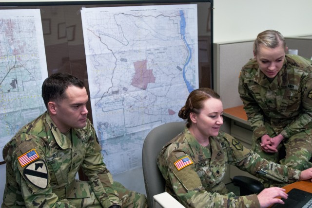 Geospatial engineers from the 301st Maneuver Enhancement Brigade work together to produce a Combined Obstacle Overlay