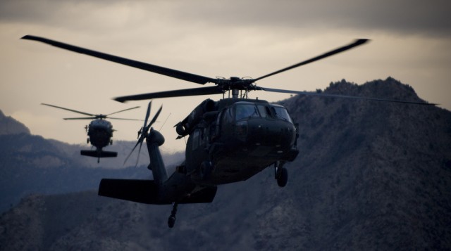 Two Army UH-60 Black Hawk helicopters prepare for landing
