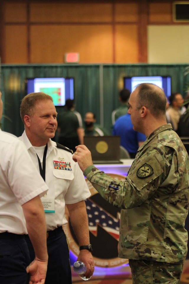 780 MI BDE DCO discusses CyberPatriot with Leilehua HS JROTC Senior Instructor