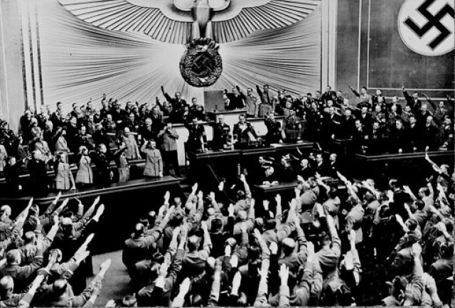 Adolf Hitler accepts the ovation of the Reichstag