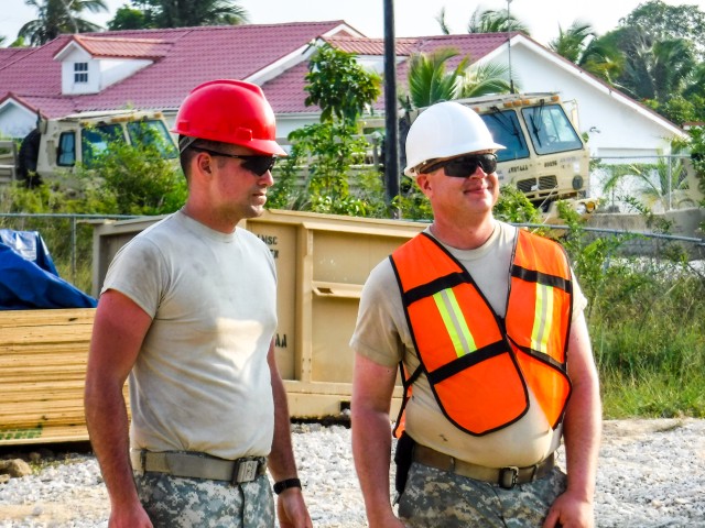 Sgt. Jason Klimesh and Spc. Patrick Ray look over the Ladyville job site