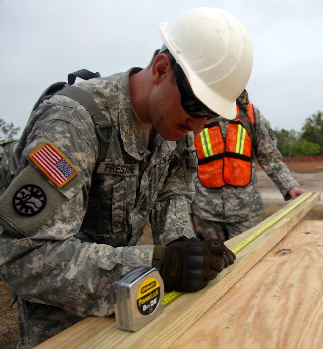 Sgt. Roman Firestone measures a piece of wood