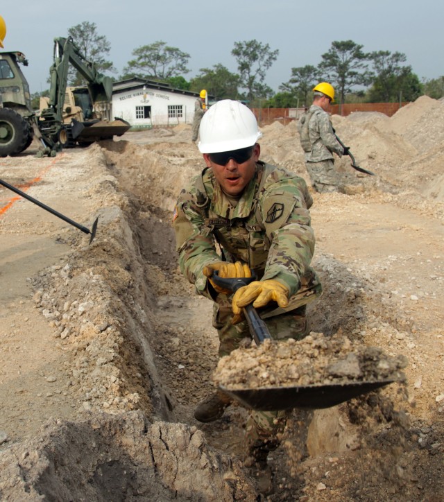 Sgt. Jacob Glueckert clears out a ditch