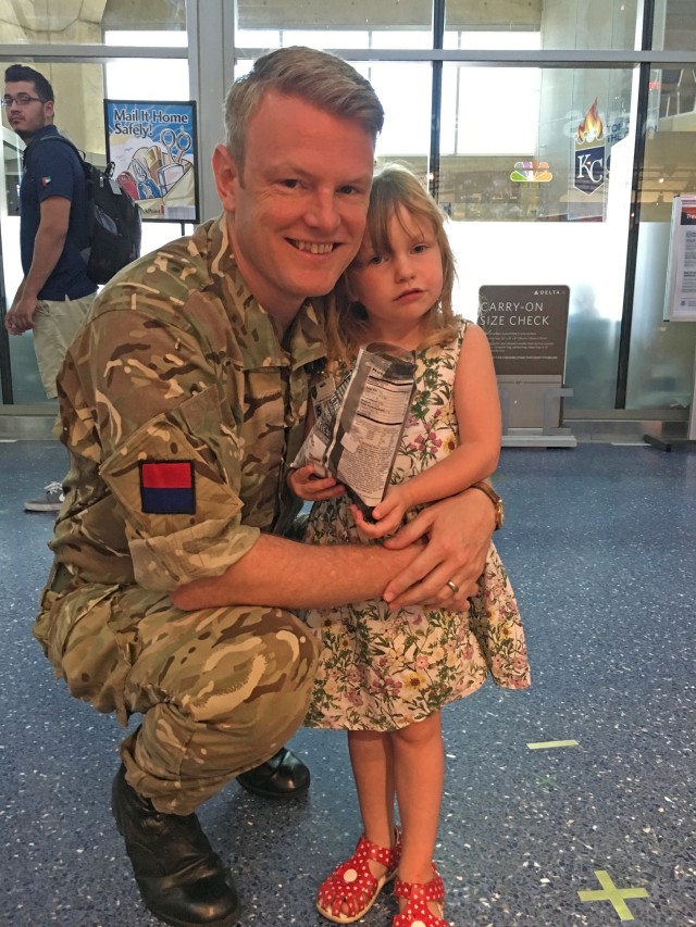 British Army Maj. Robert Steel hugs his daughter, Florence, as he prepares to leave on a 9-month deployment