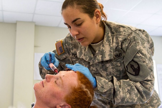 Elsamari Figueroa prepares a fake head wound