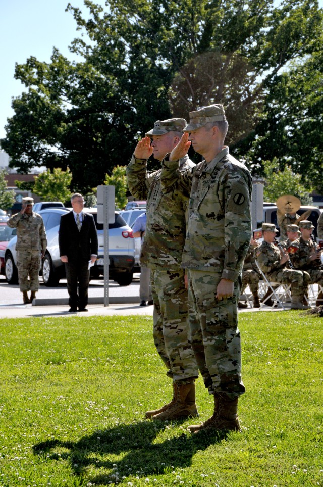 Gen. David Perkins, commanding general of U.S. Army Training and Doctrine Command, and Lt. Gen. Sean MacFarland, TRADOC deputy commanding general, salute the flag during MacFarland's welcoming ceremon