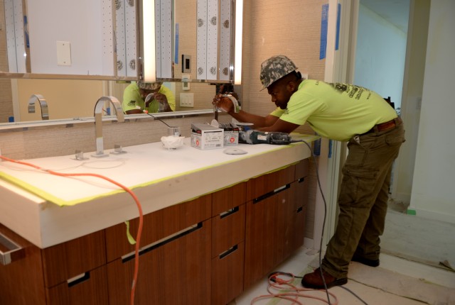 Soldier trades helmet for hard hat