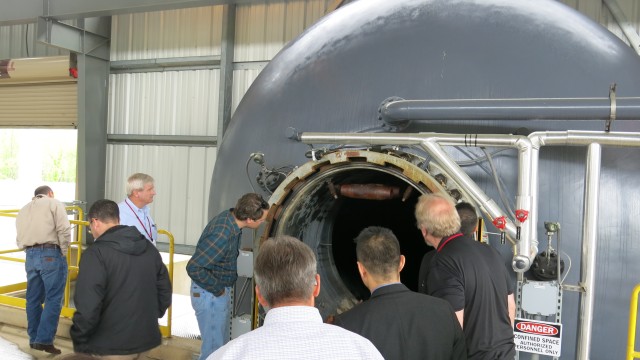 Guests from the 2017 Global Demil Symposium examine LEMC's ARMD Chamber.